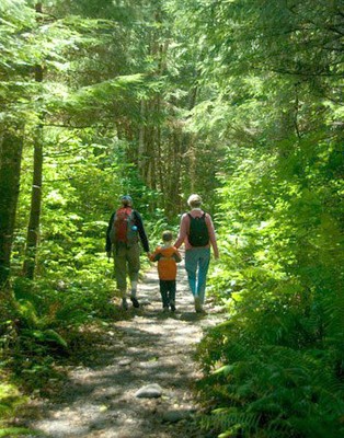 Family walking in the woods. Courtesy of benandrews.com. 