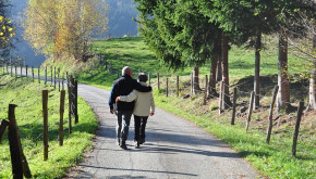 Couple walking arm-in-arm down a country road. Courtesy of pixabay.com. 