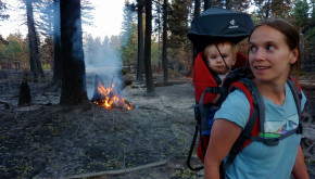 Sarah DeMay and her child surveying the damage to their family property after the Las Conchas fire in 2011.