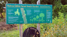Rahma Edible Forest Snack Garden sign surrounded by food garden. Photo: Catherine Bukowski, VA Tech