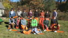 A group of women at a chainsaw training pose for a picture.