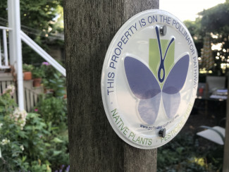 A Pollinator Pathway sign posted in a participating garden